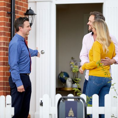Hopkins representative with a couple at the door of a showhome