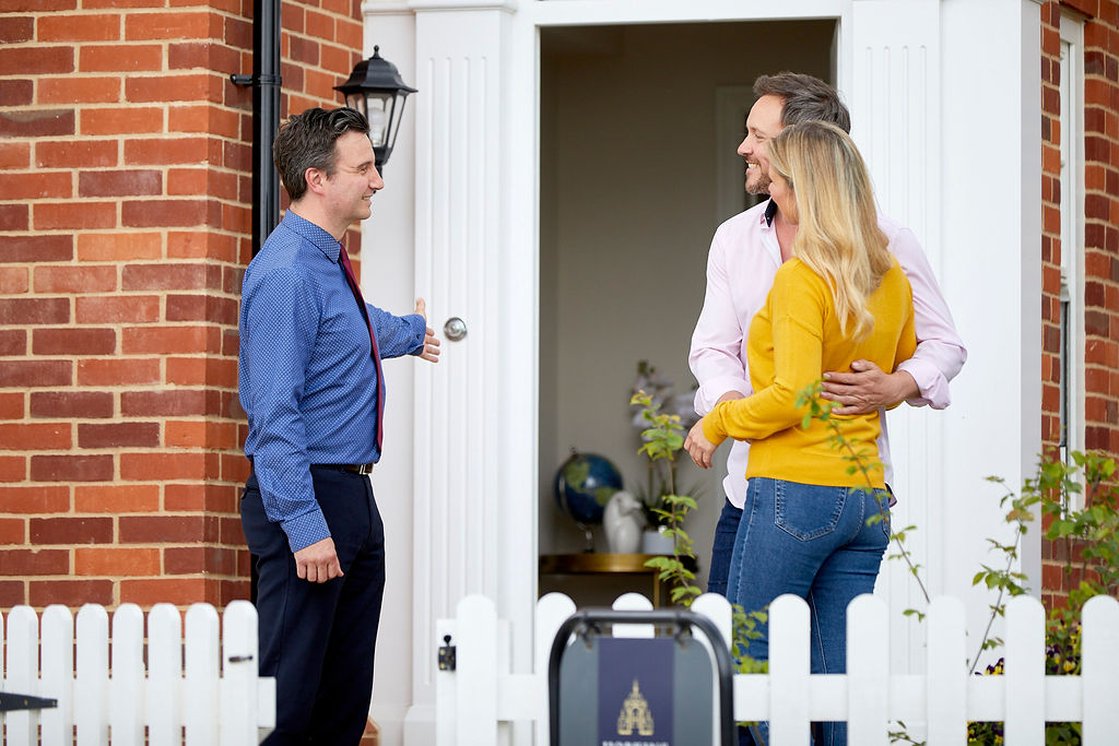 Hopkins representative with a couple at the door of a showhome