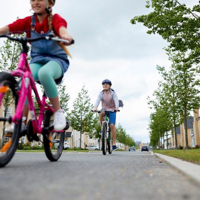 A young girl and mother riding bikes