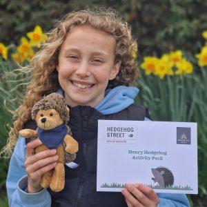 Girl withy hedgehog and leaflet