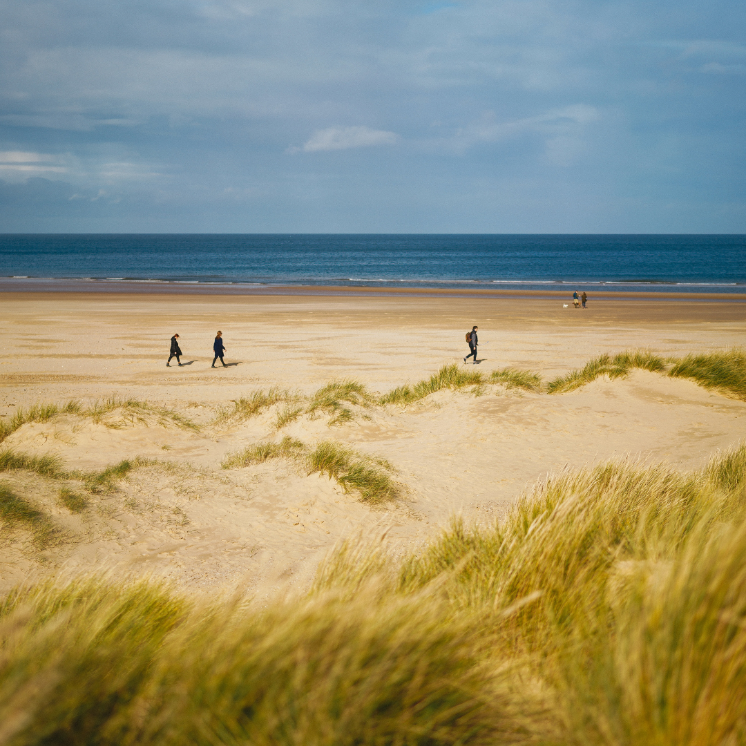 People walking on a Norfolk beach