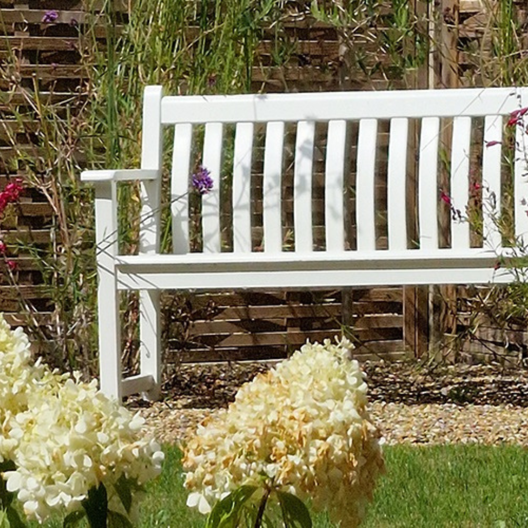 A bench in the front garden of a new build